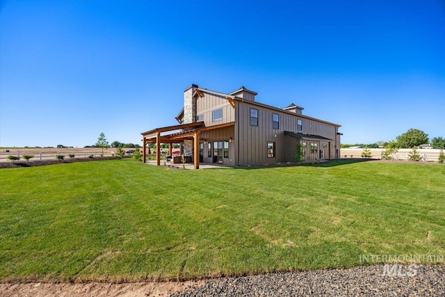 8860 Kemp Rd, Middleton, ID 83607 - back of house featuring a chimney, a patio, and board and batten siding