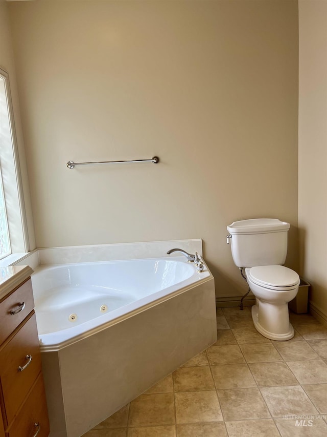 315 Shadetree Trl, Twin Falls, ID 83301 - bathroom with toilet, a tub with jets, tile patterned floors, and baseboards