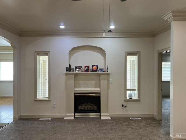 315 Shadetree Trl, Twin Falls, ID 83301 - carpeted living area featuring crown molding, healthy amount of natural light, arched walkways, a fireplace, and baseboards