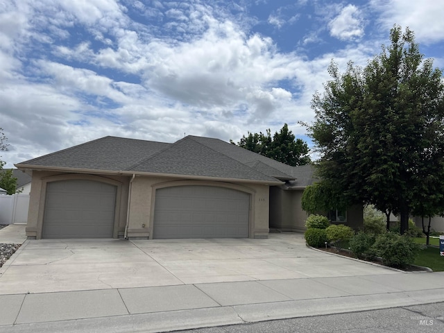 315 Shadetree Trl, Twin Falls, ID 83301 - view of front of home featuring a garage, concrete driveway, stucco siding, and roof with shingles