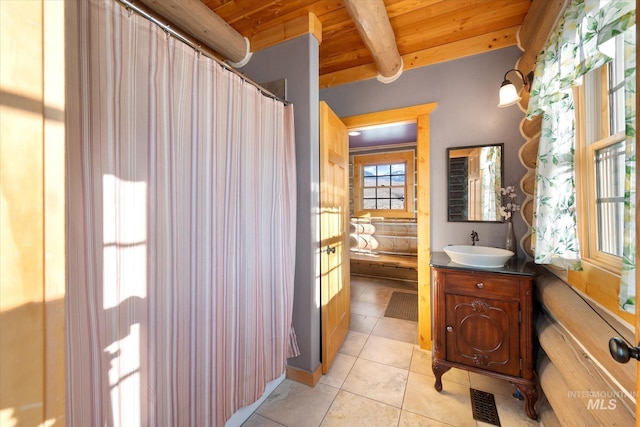 bathroom with wood ceiling, tile flooring, vanity, and beam ceiling