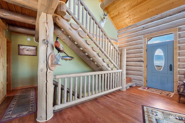 foyer entrance featuring lofted ceiling with beams, rustic walls, dark hardwood / wood-style floors, and wood ceiling