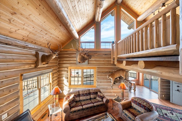 living room with a wealth of natural light, rustic walls, high vaulted ceiling, and wooden ceiling