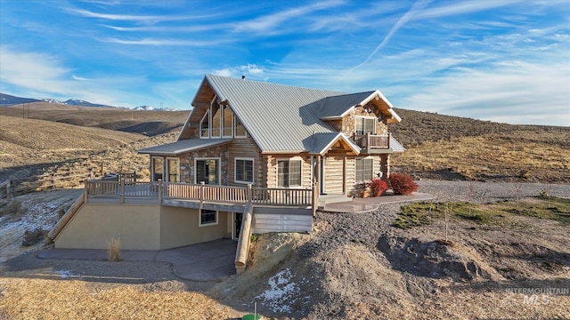 cabin featuring a deck with mountain view