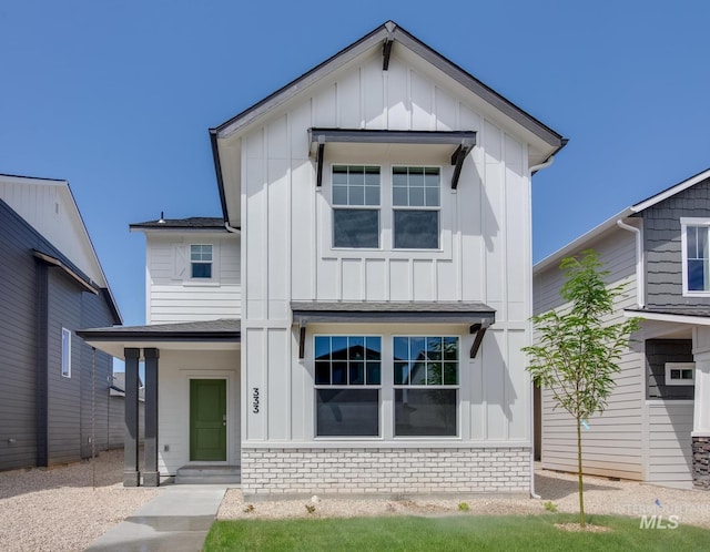modern farmhouse style home featuring a shingled roof and board and batten siding