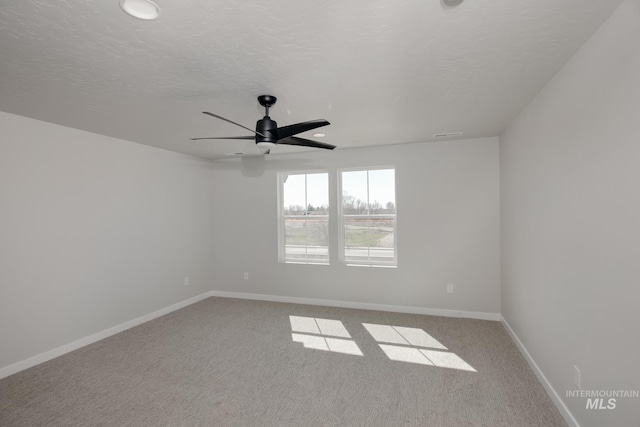 carpeted spare room featuring a ceiling fan, baseboards, recessed lighting, and a textured ceiling