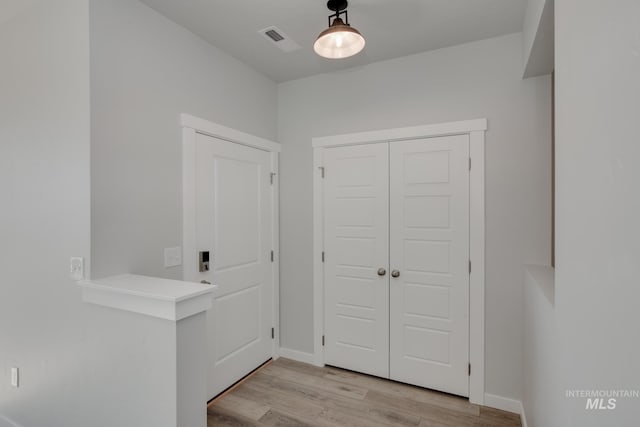 entrance foyer with visible vents, light wood-style flooring, and baseboards