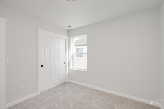 2779 N Rocky Bottom Way, Kuna, ID 83634 - unfurnished bedroom featuring light carpet, baseboards, and a closet