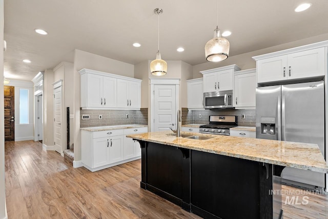 13991 W Milford Dr, Boise, ID 83713 - kitchen with stainless steel appliances, a breakfast bar, white cabinets, and recessed lighting