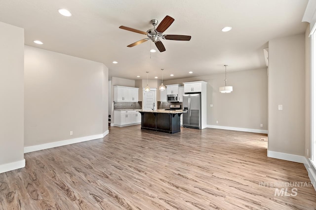 13991 W Milford Dr, Boise, ID 83713 - unfurnished living room featuring ceiling fan, baseboards, light wood-style floors, recessed lighting, and a sink