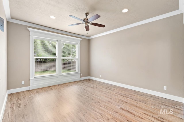 13991 W Milford Dr, Boise, ID 83713 - spare room with light wood-style flooring, ceiling fan, baseboards, a textured ceiling, and crown molding
