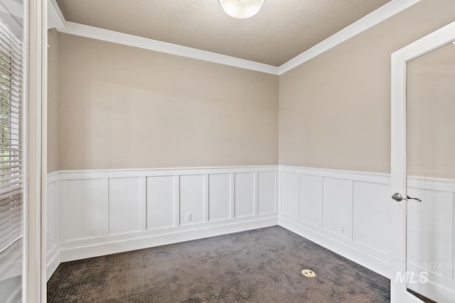 13991 W Milford Dr, Boise, ID 83713 - empty room featuring dark carpet, wainscoting, a decorative wall, and ornamental molding
