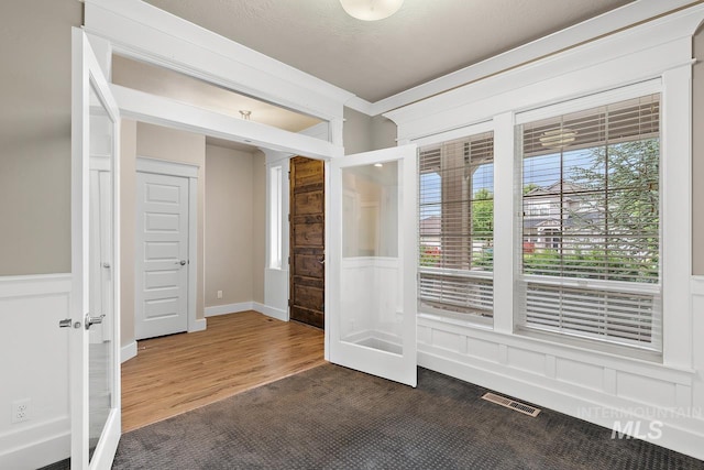 13991 W Milford Dr, Boise, ID 83713 - spare room featuring wood finished floors and wainscoting