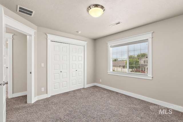13991 W Milford Dr, Boise, ID 83713 - unfurnished bedroom featuring carpet flooring, a closet, baseboards, and a textured ceiling
