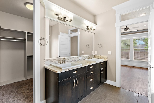13991 W Milford Dr, Boise, ID 83713 - bathroom featuring double vanity, a ceiling fan, baseboards, and a spacious closet
