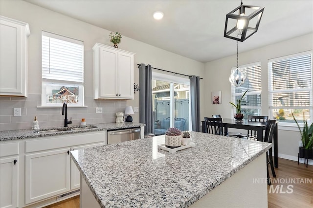 kitchen featuring pendant lighting, white cabinetry, and a kitchen island
