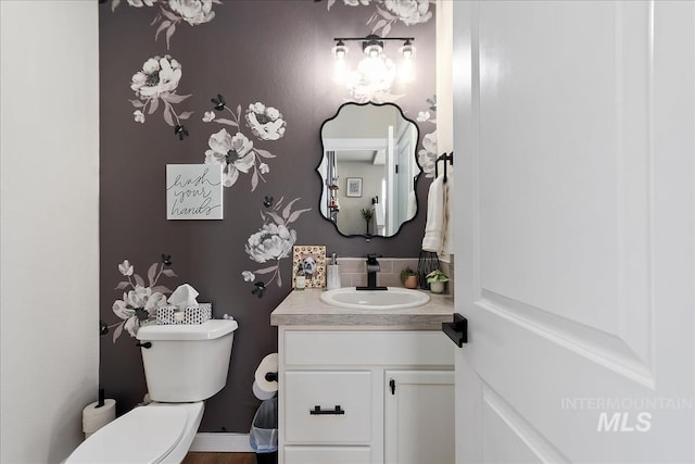 bathroom featuring vanity and toilet