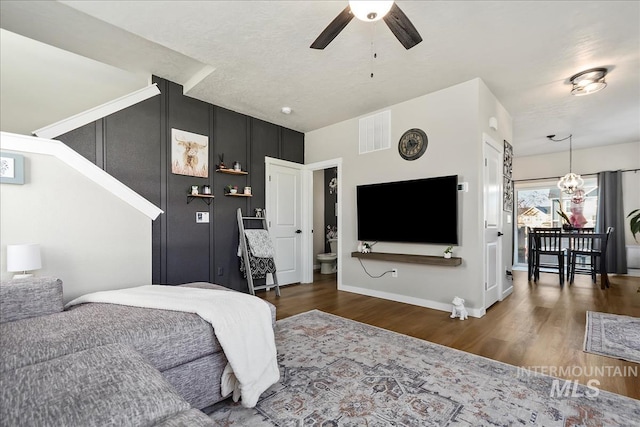 bedroom featuring ceiling fan, dark wood-type flooring, and a textured ceiling