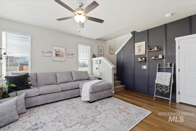 living room with hardwood / wood-style floors and ceiling fan