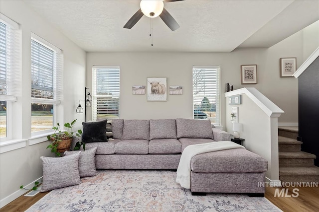living room with hardwood / wood-style flooring, a wealth of natural light, and a textured ceiling