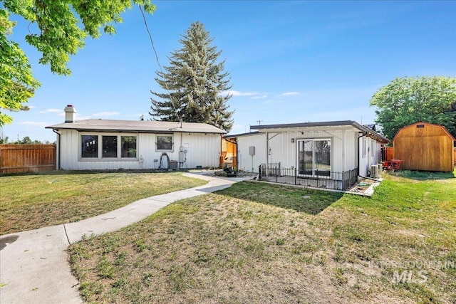 167 W Robbins, Twin Falls, ID 83301 - rear view of property featuring a storage shed and a chimney