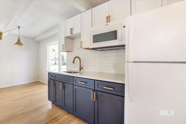 167 W Robbins, Twin Falls, ID 83301 - kitchen with white appliances, tasteful backsplash, white cabinets, light wood-style flooring, and light countertops