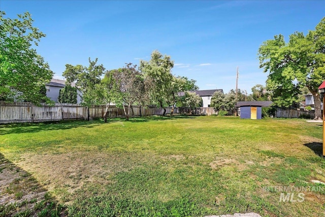 167 W Robbins, Twin Falls, ID 83301 - fenced backyard featuring a storage unit