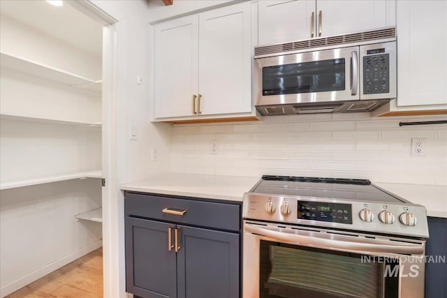 167 W Robbins, Twin Falls, ID 83301 - kitchen with stainless steel appliances, open shelves, decorative backsplash, and light countertops