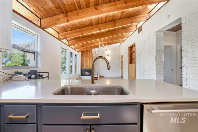 167 W Robbins, Twin Falls, ID 83301 - kitchen with dishwasher, gray cabinets, a wood ceiling with exposed beams, brick wall, and light countertops
