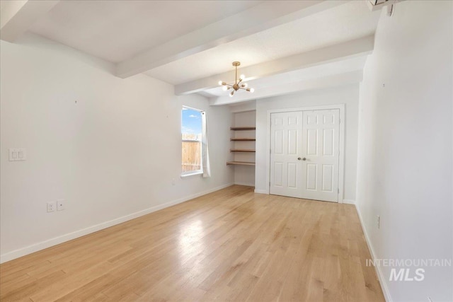 167 W Robbins, Twin Falls, ID 83301 - unfurnished bedroom with a chandelier, beam ceiling, and light wood-style floors