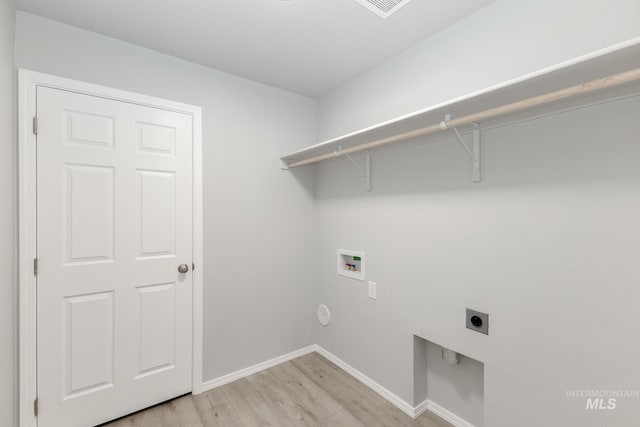 laundry area featuring baseboards, hookup for an electric dryer, hookup for a washing machine, and laundry area