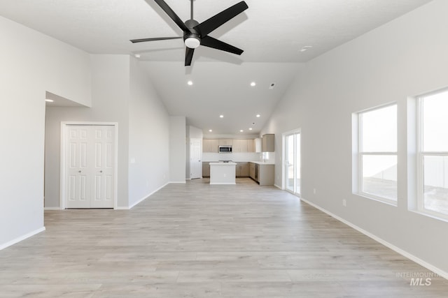 unfurnished living room featuring light wood-type flooring, high vaulted ceiling, recessed lighting, baseboards, and ceiling fan