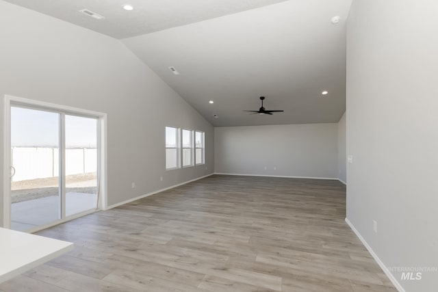 empty room featuring light wood-type flooring, high vaulted ceiling, a ceiling fan, recessed lighting, and baseboards