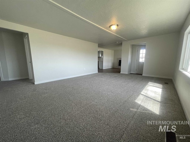956 SE Hamilton Rd, Mountain Home, ID 83647 - carpeted empty room featuring baseboards and a textured ceiling
