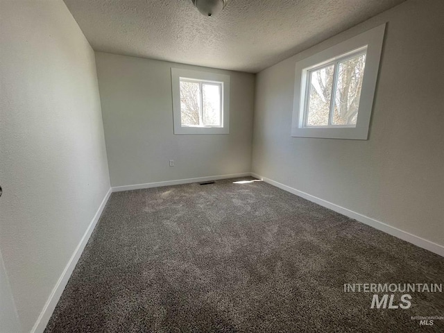 956 SE Hamilton Rd, Mountain Home, ID 83647 - carpeted spare room with a textured ceiling and baseboards