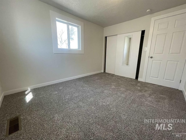 956 SE Hamilton Rd, Mountain Home, ID 83647 - unfurnished bedroom featuring baseboards, a textured ceiling, a closet, and carpet floors