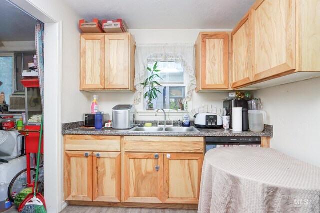 kitchen featuring dishwasher, light brown cabinetry, sink, and light hardwood / wood-style flooring