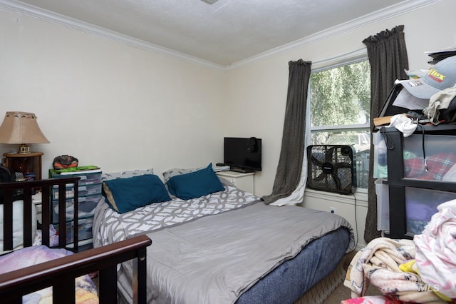 bedroom featuring a textured ceiling and ornamental molding