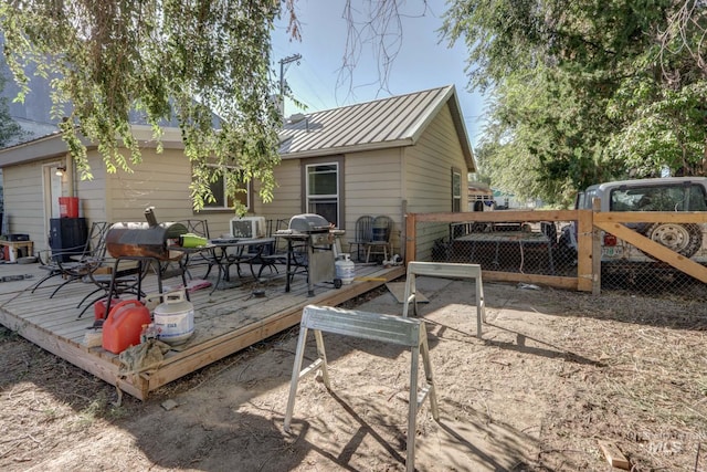 rear view of property featuring a deck