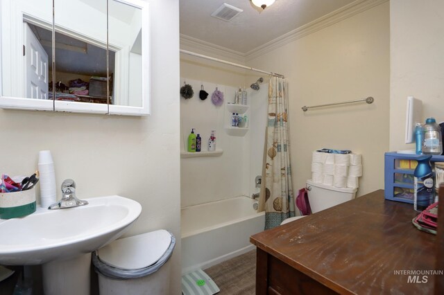 full bathroom with crown molding, toilet, shower / tub combo, and sink