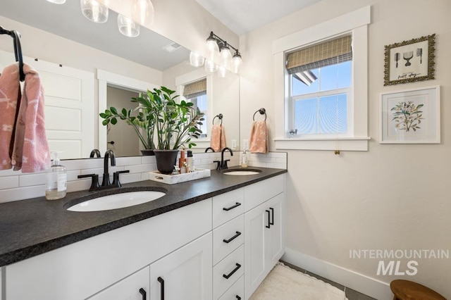 10411 Hazy Glen Dr, Nampa, ID 83687 - full bathroom featuring double vanity and tasteful backsplash