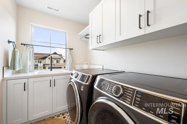 10411 Hazy Glen Dr, Nampa, ID 83687 - laundry room featuring washing machine and clothes dryer and cabinet space