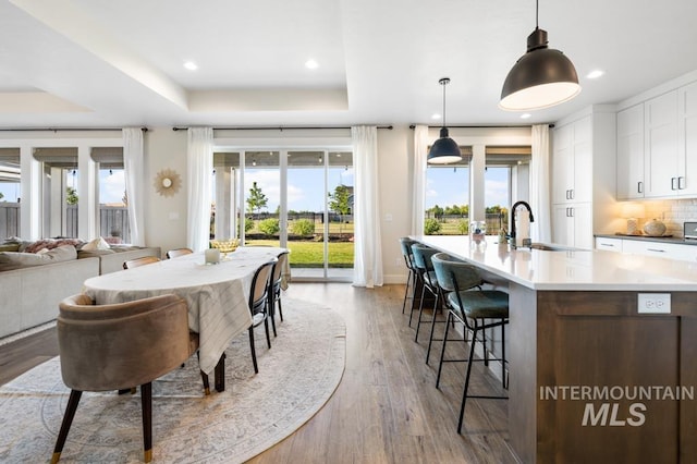 10411 Hazy Glen Dr, Nampa, ID 83687 - dining area with plenty of natural light, a tray ceiling, wood finished floors, and recessed lighting