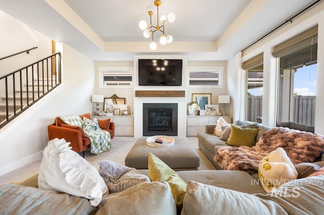 10411 Hazy Glen Dr, Nampa, ID 83687 - living area featuring a fireplace, a chandelier, stairway, carpet flooring, and a tray ceiling