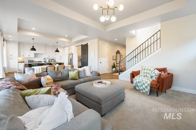 10411 Hazy Glen Dr, Nampa, ID 83687 - living room with a barn door, a tray ceiling, recessed lighting, stairway, and a chandelier