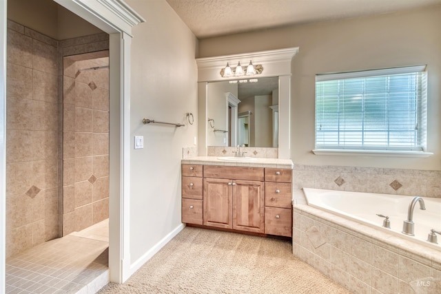 bathroom featuring vanity, a textured ceiling, tiled shower, baseboards, and a bath