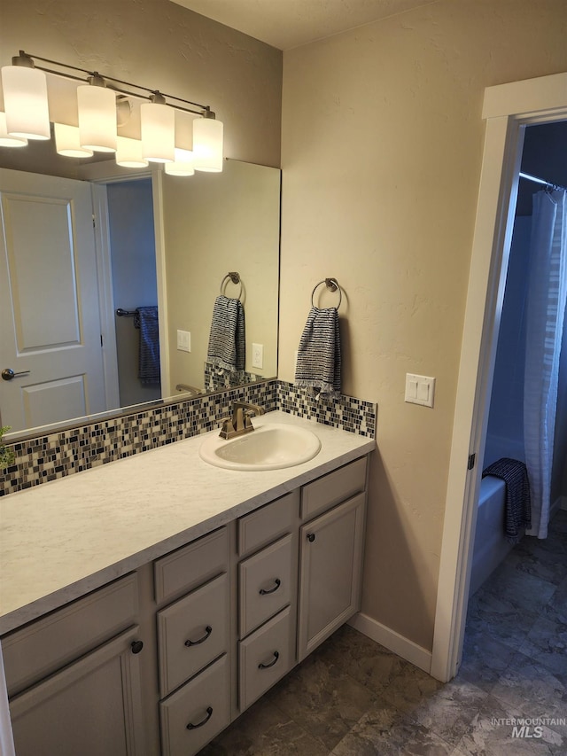 bathroom with vanity, decorative backsplash, and shower / bath combo