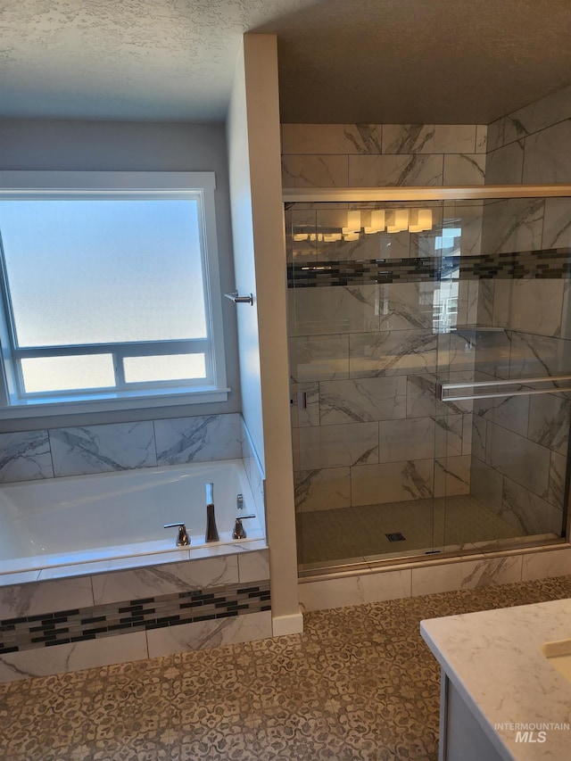 bathroom with tile patterned flooring, vanity, and shower with separate bathtub