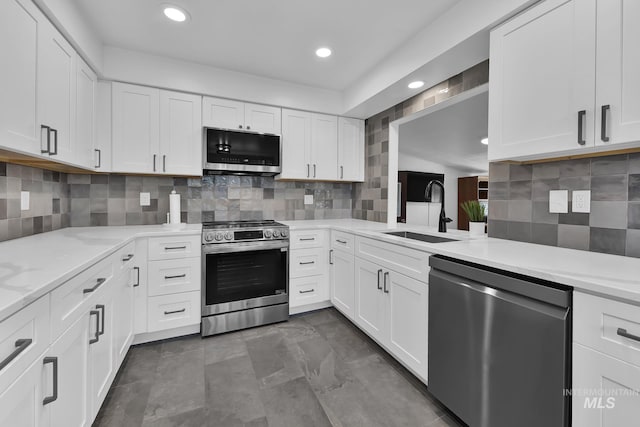 2323 W Lemhi St, Boise, ID 83705 - kitchen with decorative backsplash, appliances with stainless steel finishes, a sink, recessed lighting, and white cabinetry