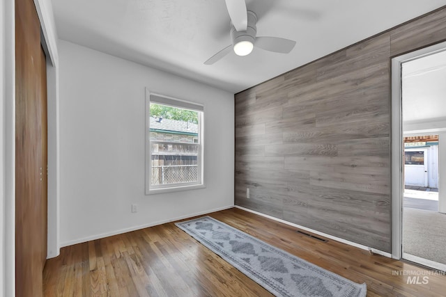 2323 W Lemhi St, Boise, ID 83705 - unfurnished room featuring visible vents, an accent wall, wood finished floors, baseboards, and ceiling fan